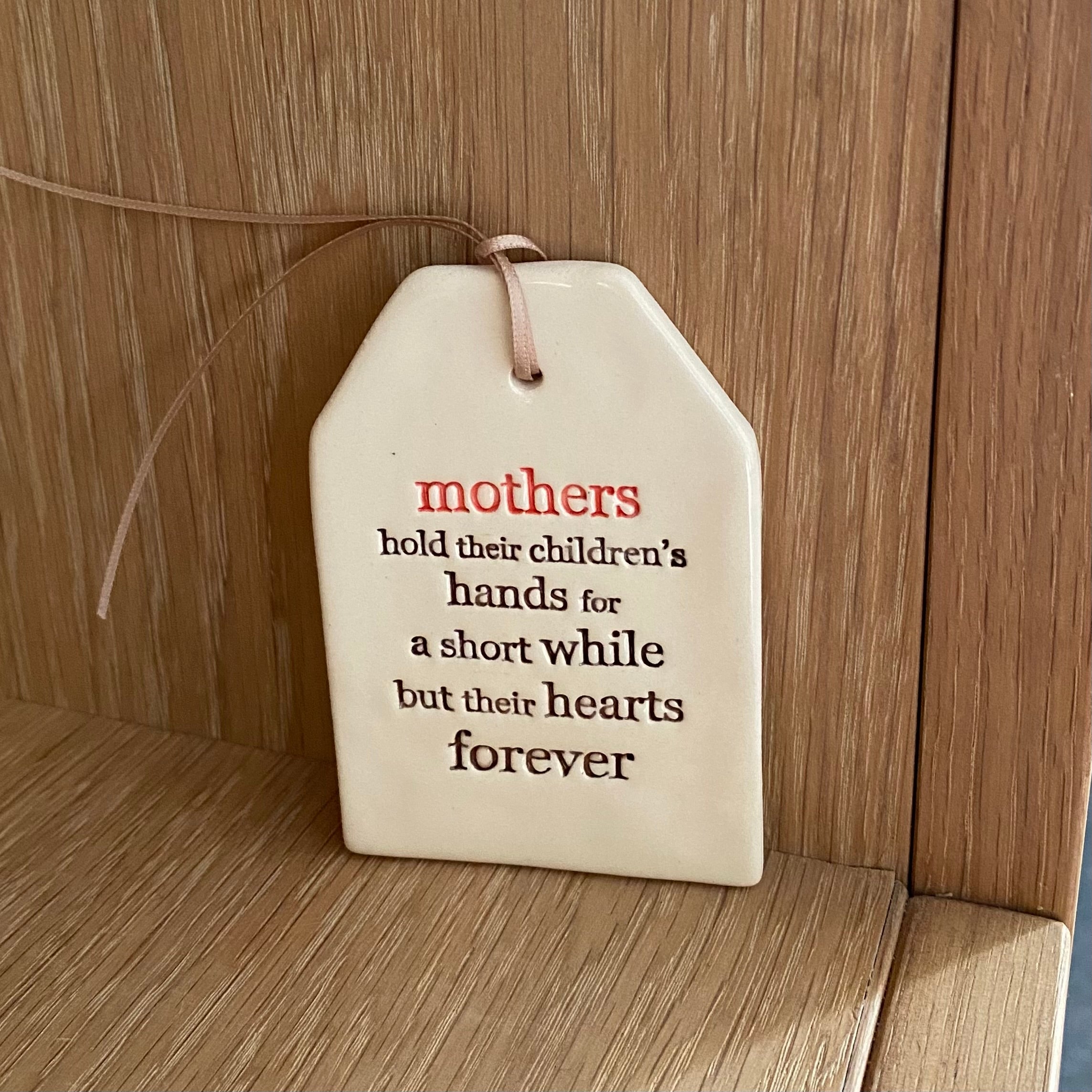 Paper Boat Press quote tag - mothers hold their children's....