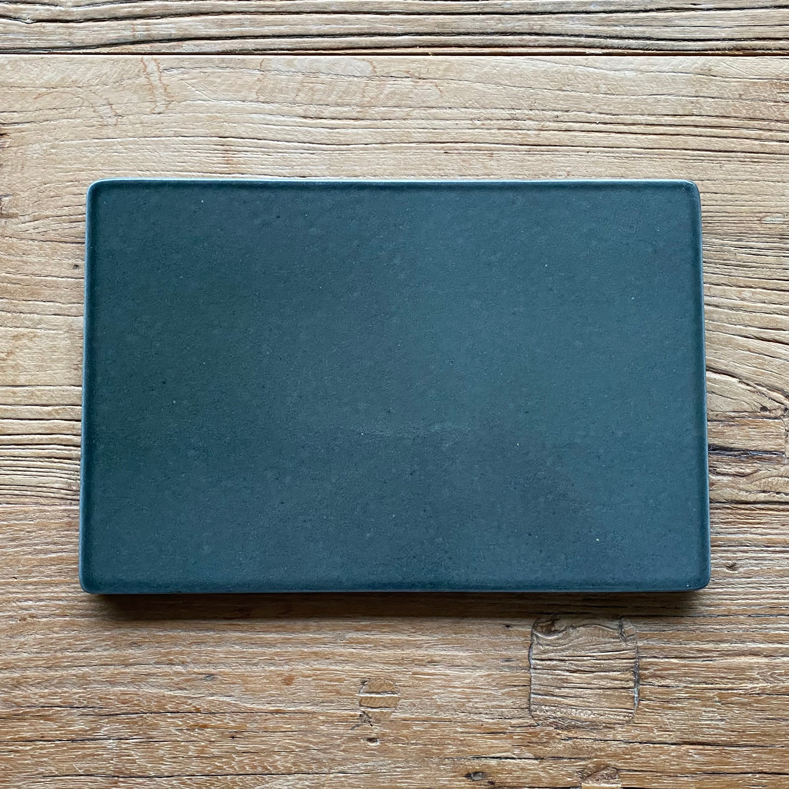 Lavastensbræt i mørk grågrøn lavasten brugt til servering og borddækning