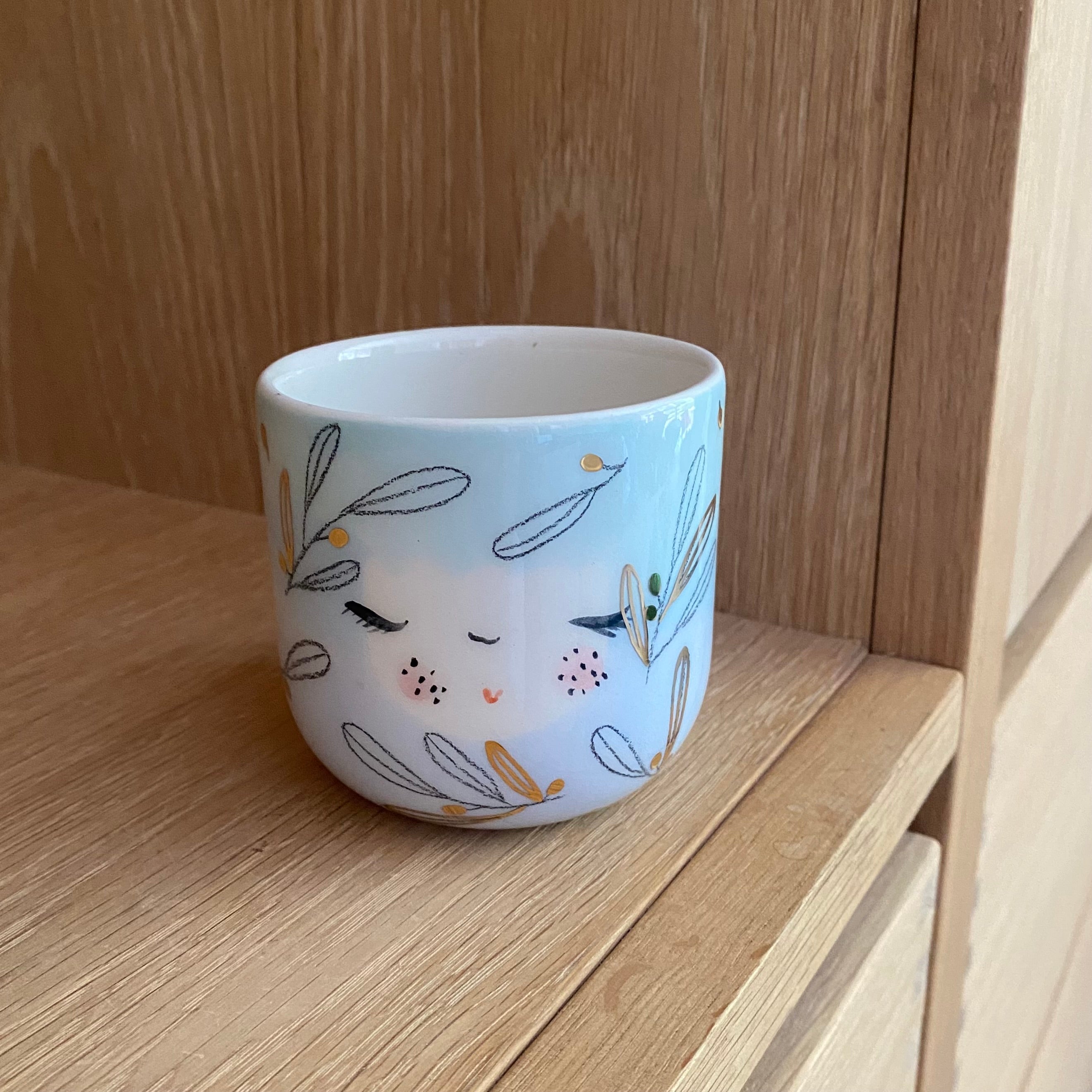 Detalje af keramik cappuccinokop med guld og pastelfarver – håndlavet fra Marinski