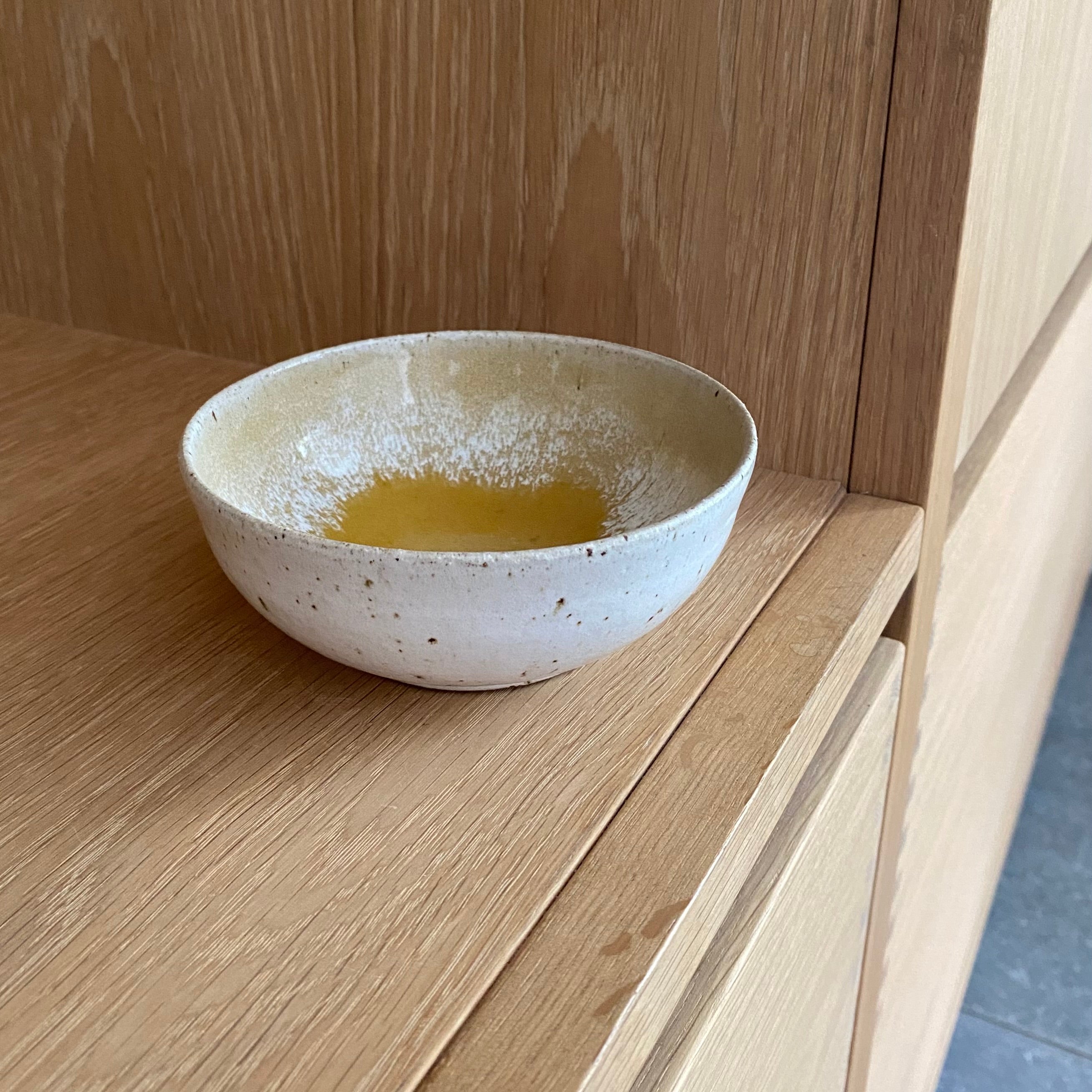 Lille håndlavet keramikskål i varm gul og creme fra unika:k